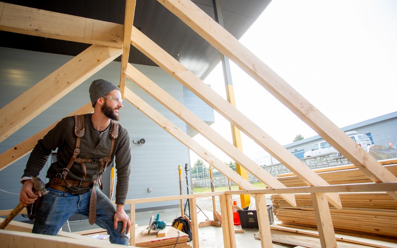 A man framing a structure. 
